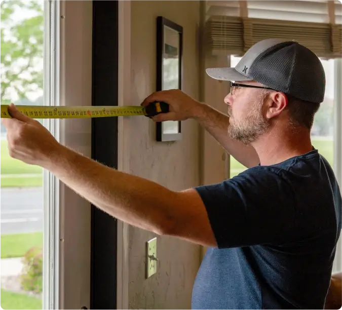 Handyman measuring a wall